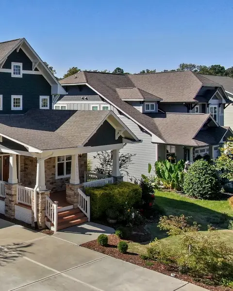 Two-story craftsman with a deep front porch and attached garage