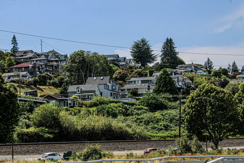 Hillside homes above a rail line and greenery near the Tacoma waterfront